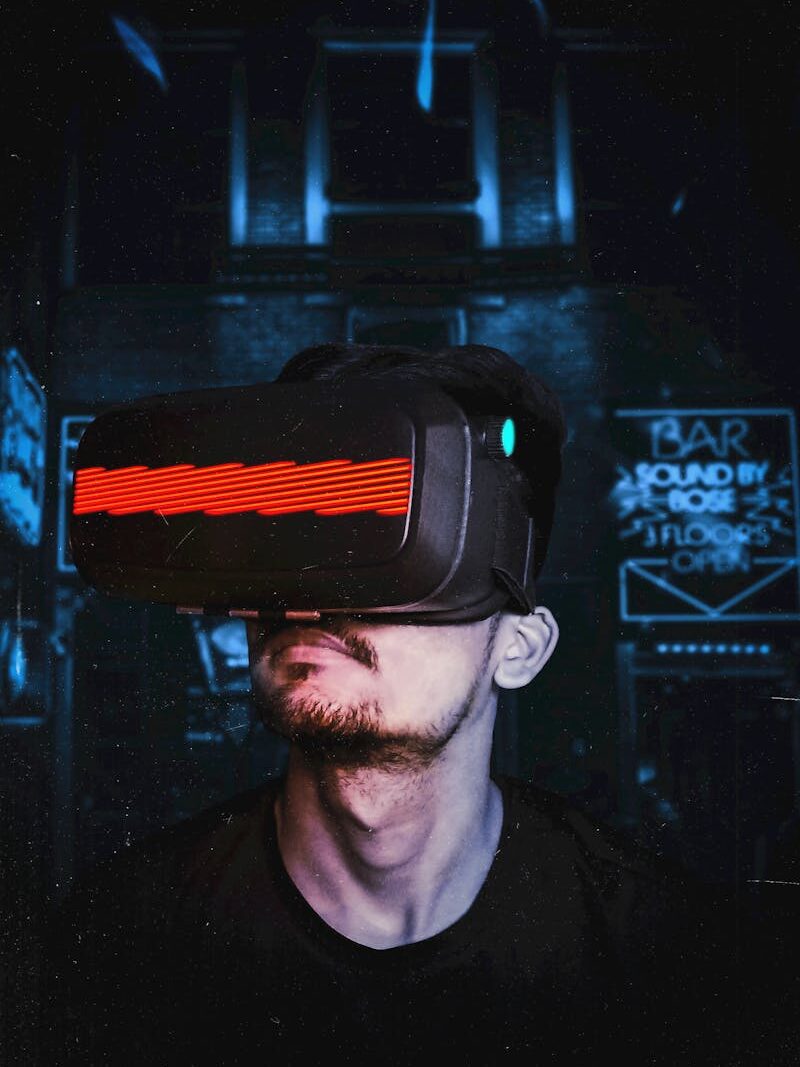 Home Young man immersed in a virtual reality experience using a VR headset, showcasing futuristic tech in a gaming environment.