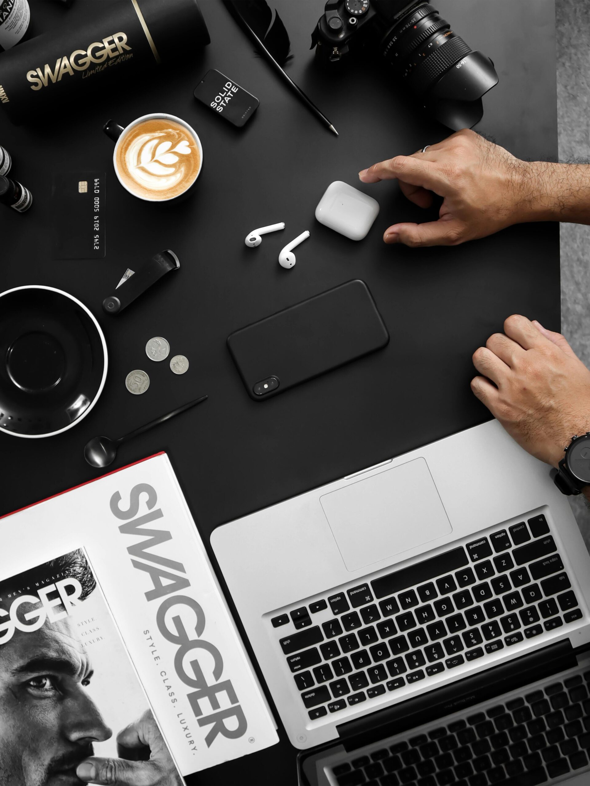 Home A contemporary workspace featuring tech devices, coffee, and a stylish magazine.